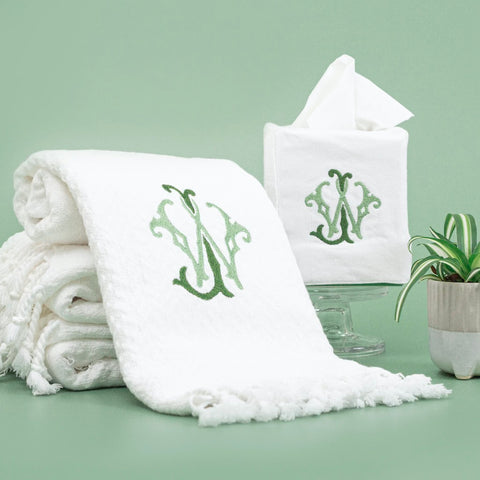 Bathroom accessories embroidered with a monogram including a hand towel and tissue box cover