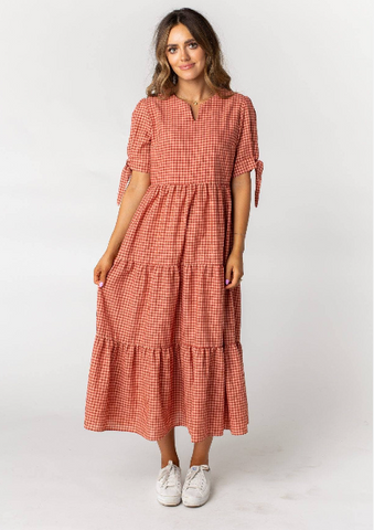 Woman wearing a long gingham Called To Surf winter dress
