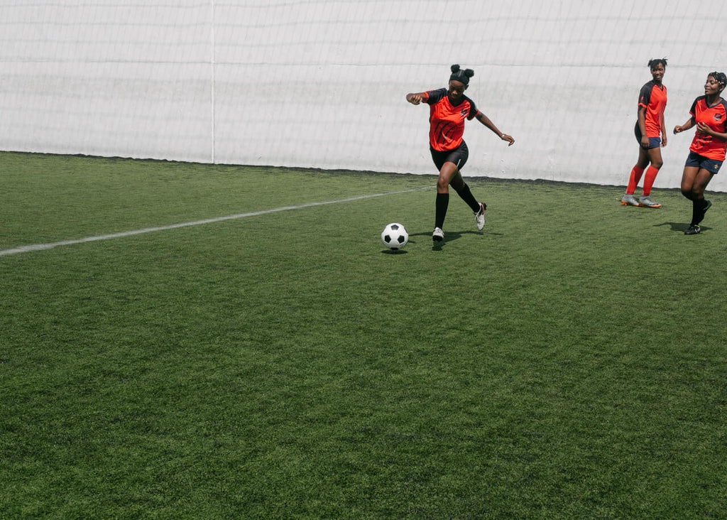 young girl soccer player practicing first touch drill