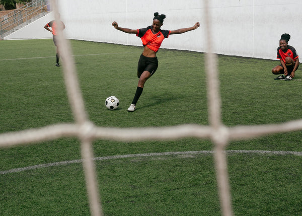 During the game, a soccer player kicked the ball