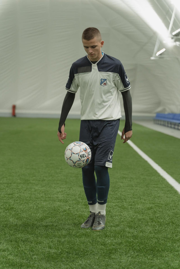 soccer player practicing juggling soccer ball