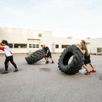men_women_athletes_exercise_tire_flip_race_fun_pic