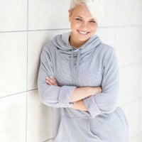 woman_young_white_hair_wall_lean_crossed_arms_smile_happy_secure_pic