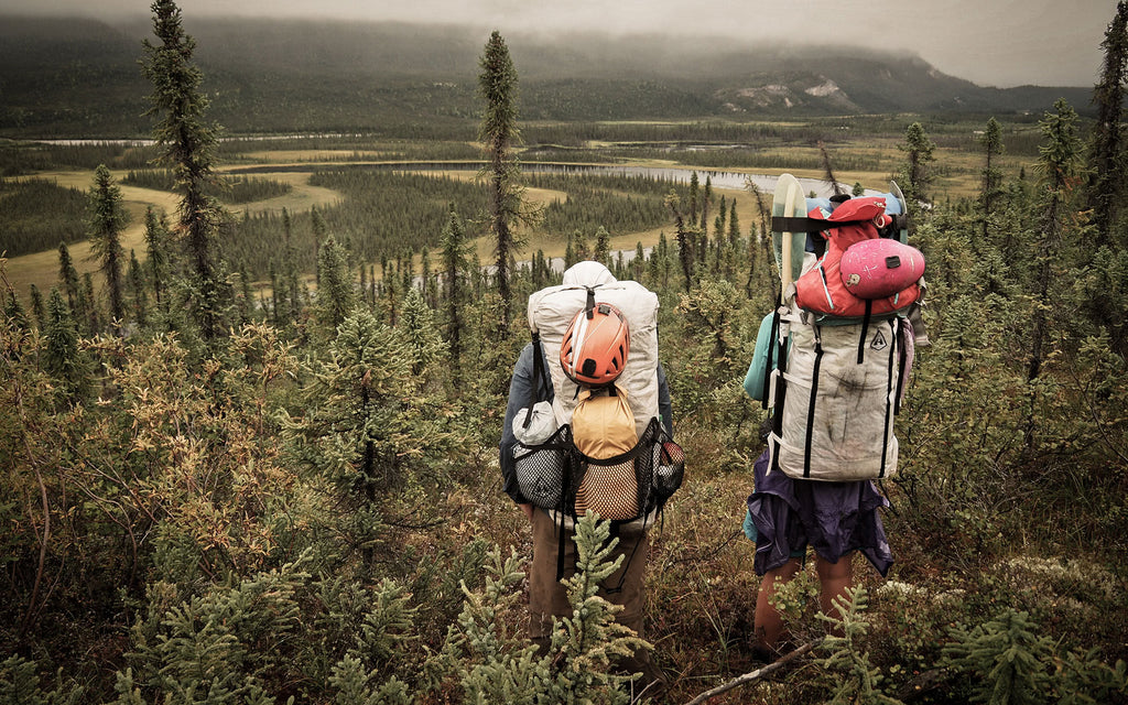 Ultralight backpackers look down over a road