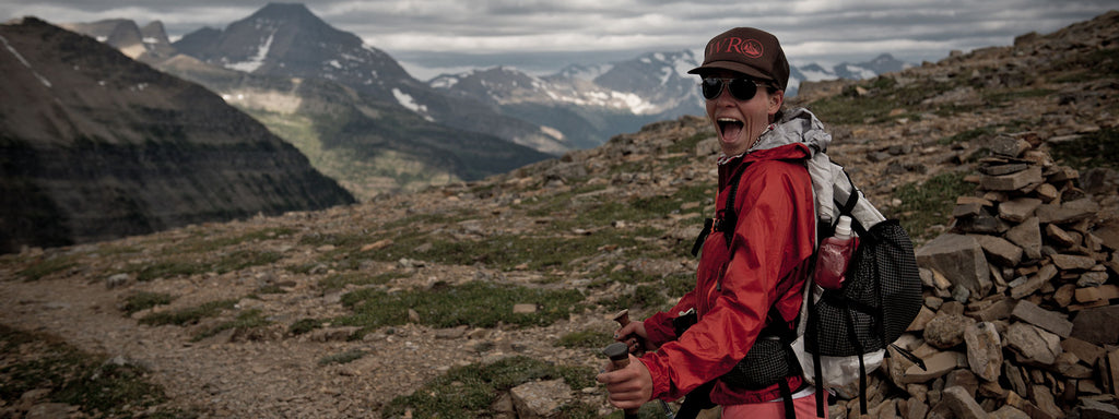 Ultralight backpacker poses on a peak