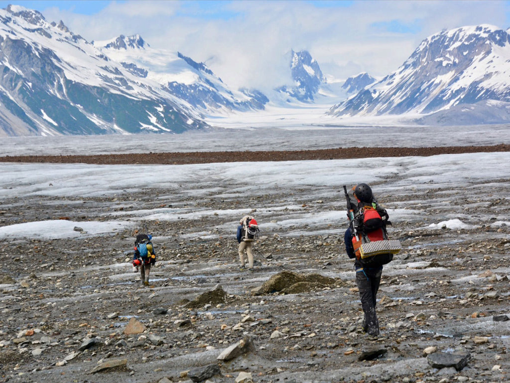 Ultralight backpackers hiking through an icy field