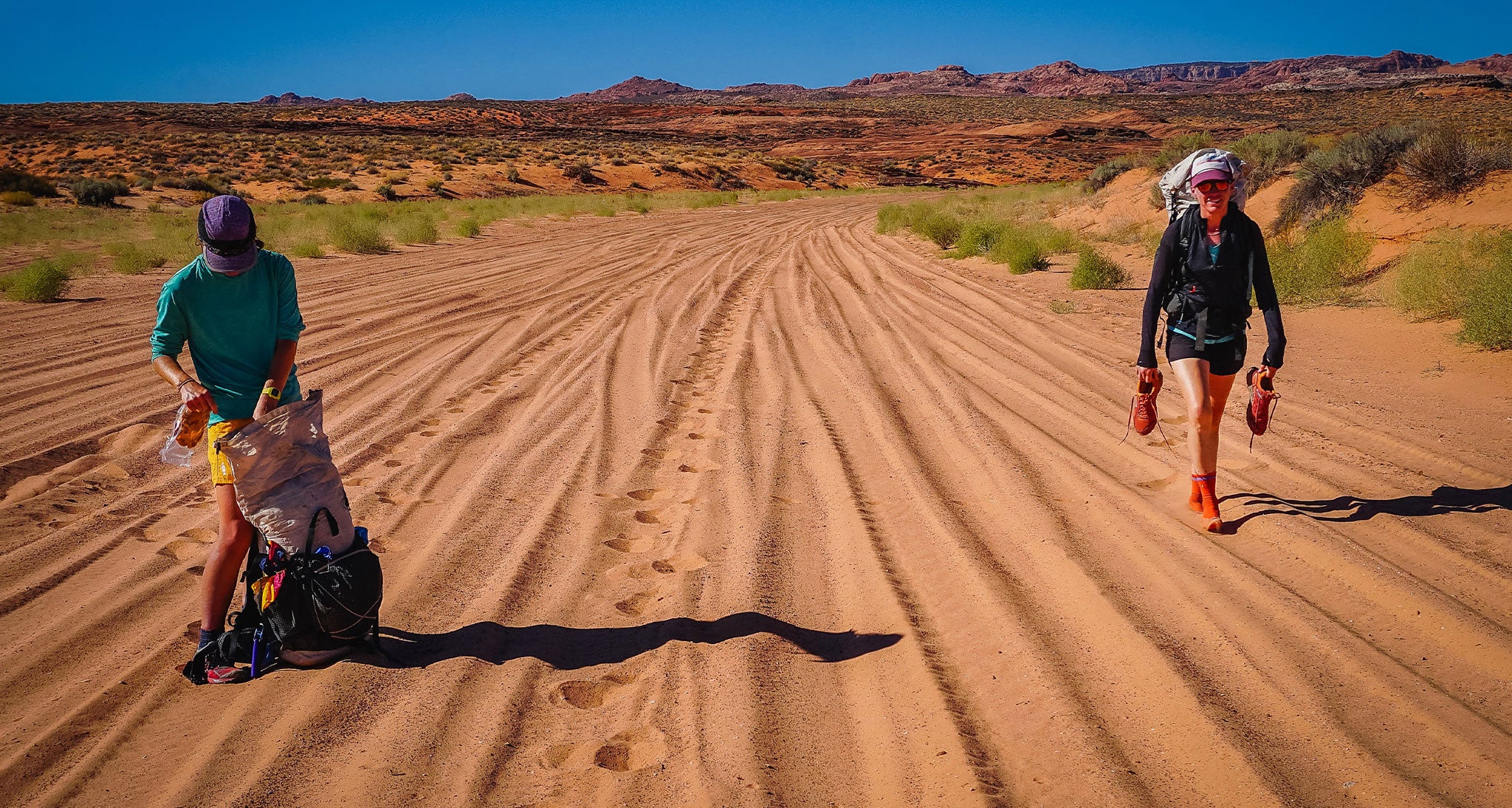 Hikers on a dusty desert trail