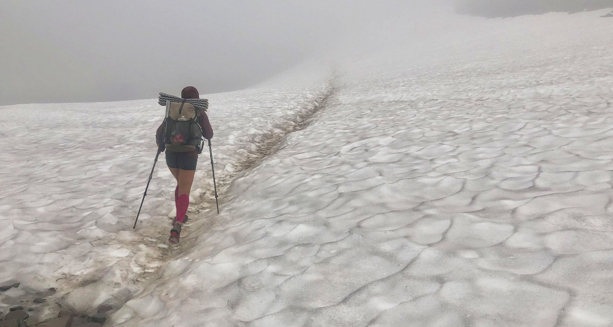 Ultralight thru hiker hikes through snow