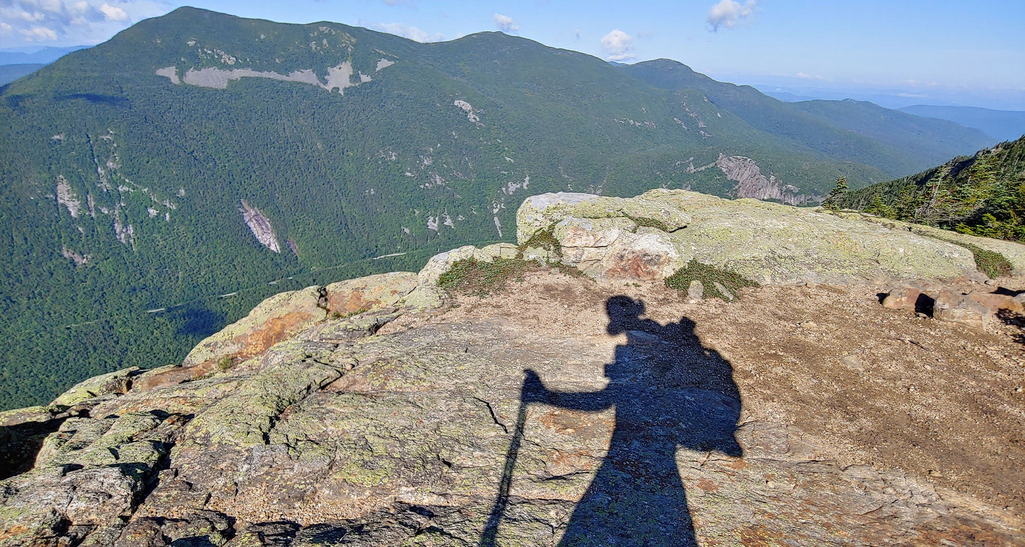 Shadow of hiker on the rock