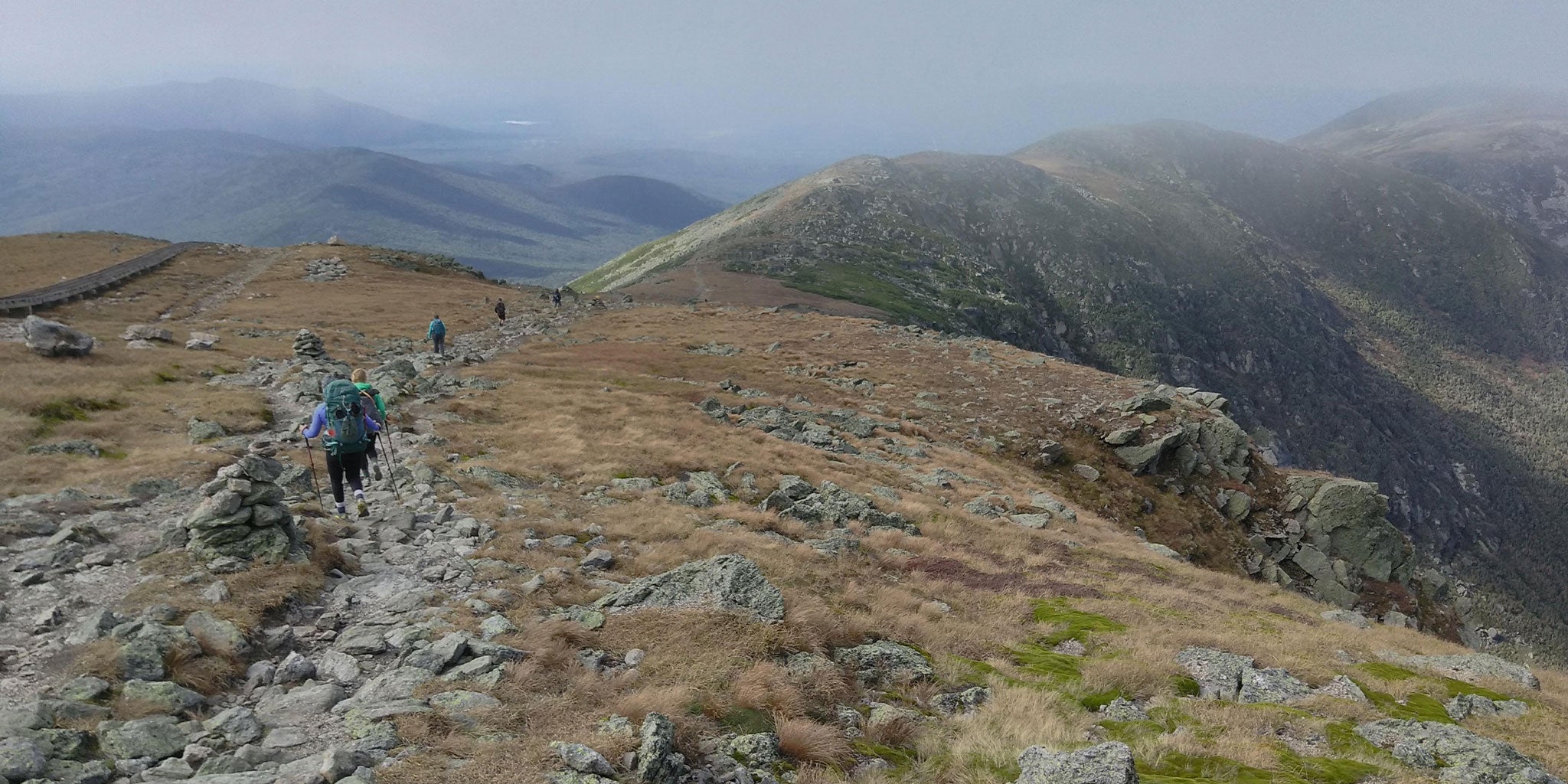 Group descends mountain on overcast day