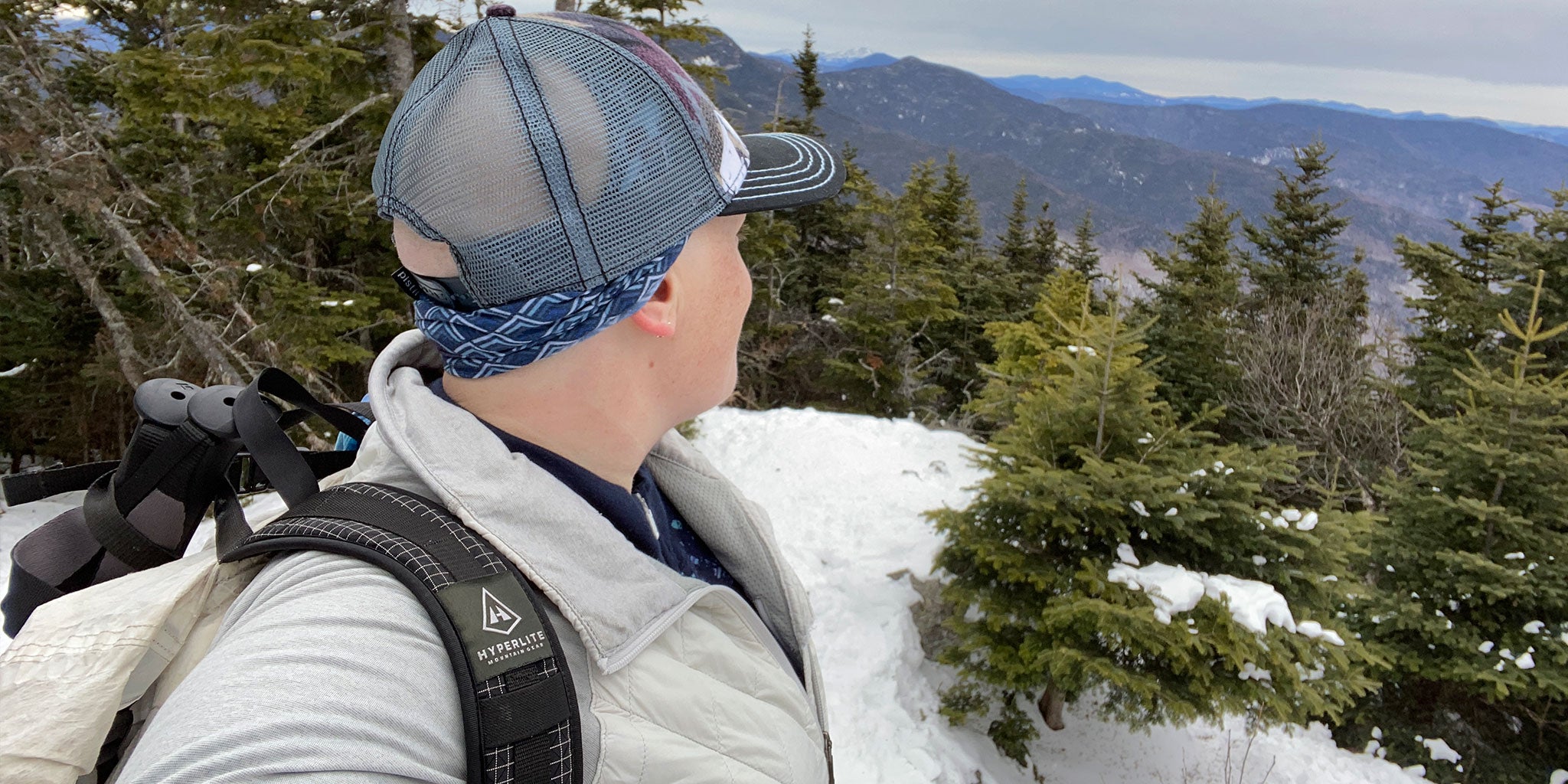 Hiker gazes over mountain edge