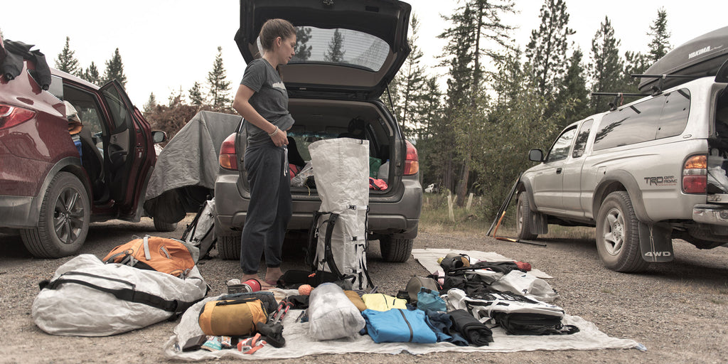 Thru Hiker packing gear in car