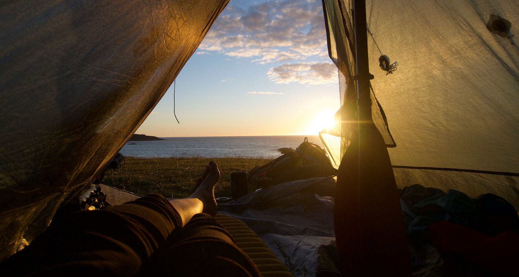 Laying in the tent, coastal sunset