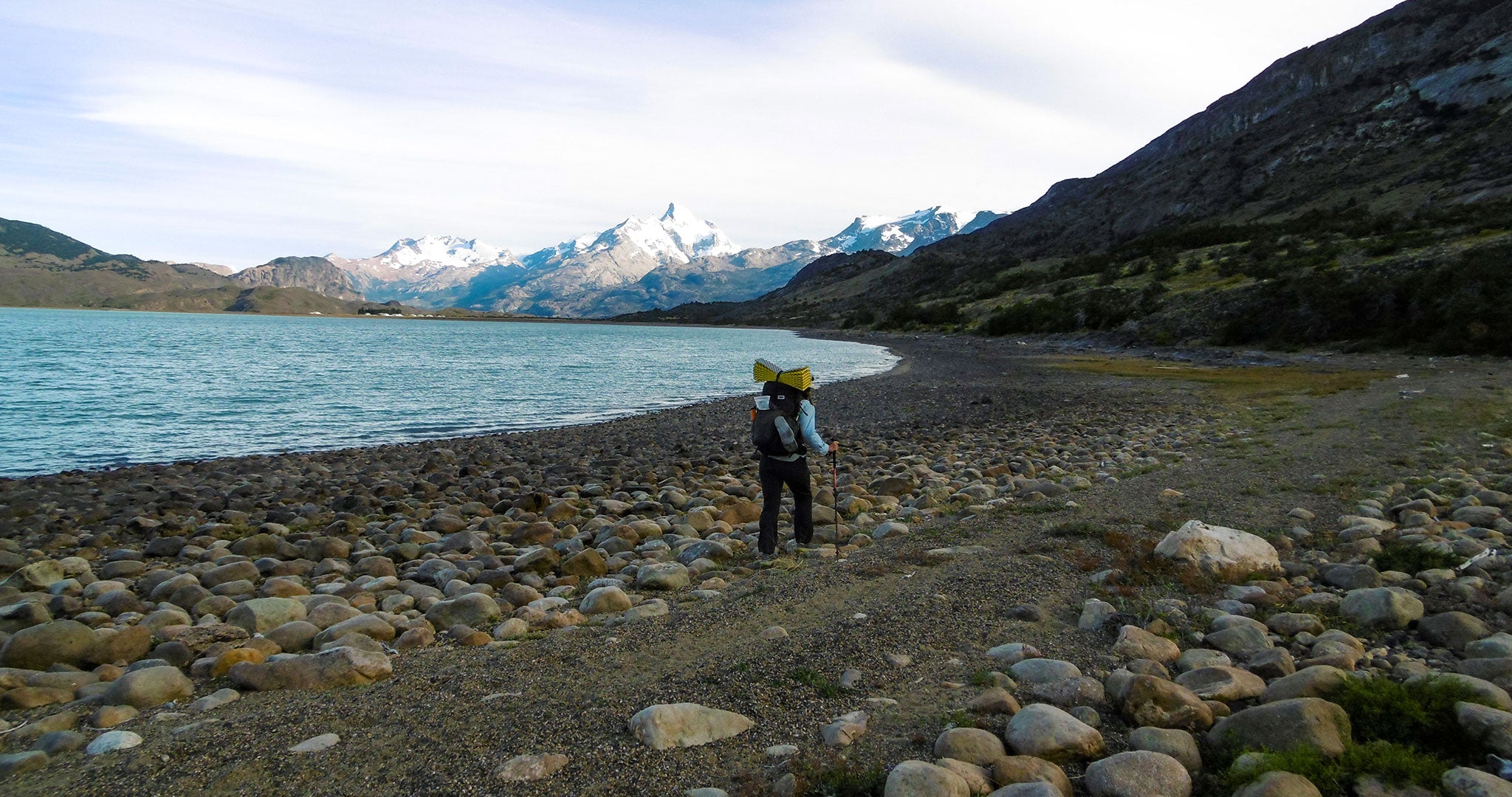 Ultralight Backpacker walking along a rocky beach