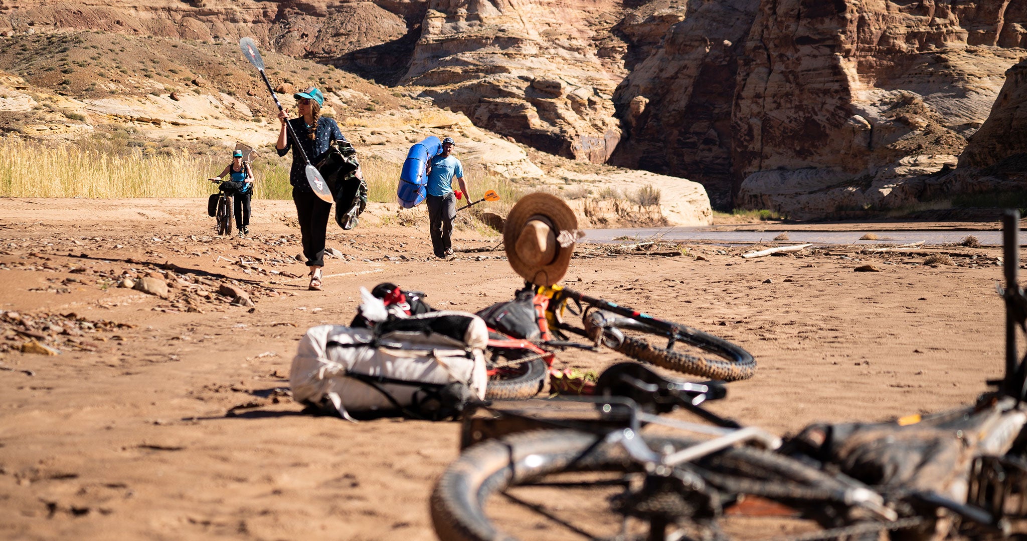 People carrying paddles and gear