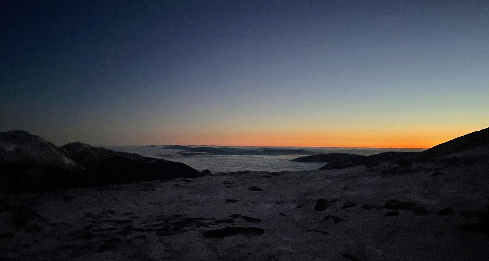 Mountain sunset above the clouds