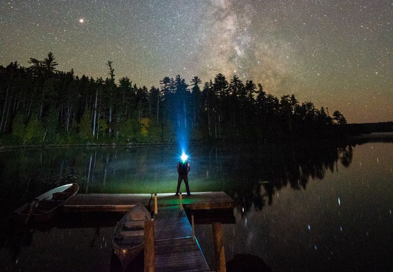 Wearing a headlamp on the dock at night, gazing at the stars above