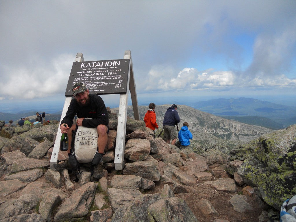 Thru Hiker posing at peak of Katahdin