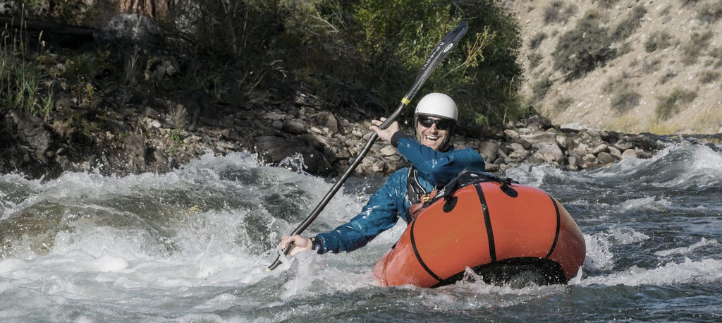  man Whitewater Packrafting while smiling