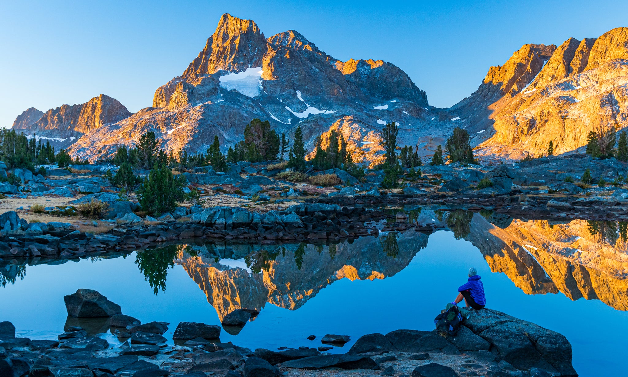 Monolithic mountain reflects off Alpine lake