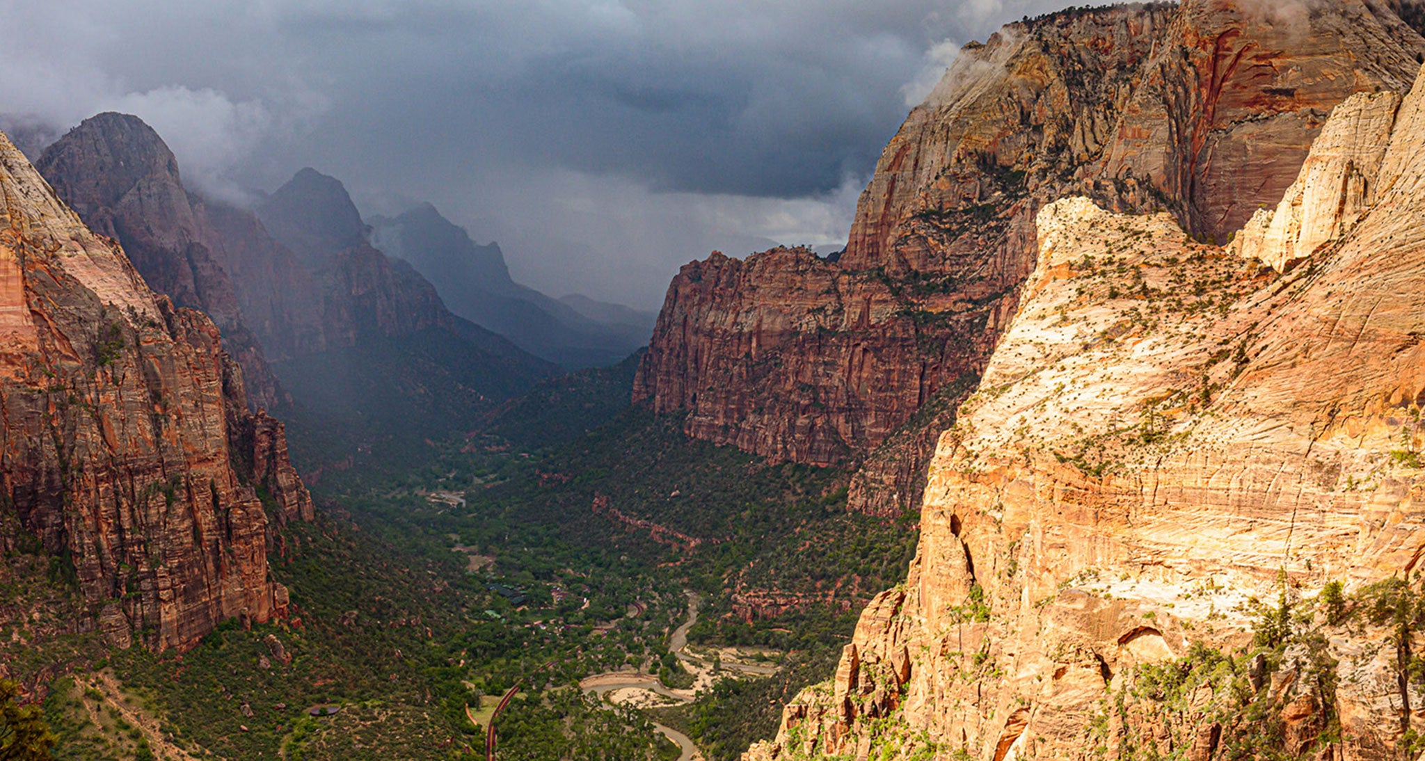 This is a rapidly developing GTFO situation on the summit of Angel's Landing in Zion National Park, Utah.  Looking south toward Zion Canyon entrance are the telltale signs of a cumulonimbus cloud-darkening bases, shafts of rain and the formation of ragged low clouds beneath the base that signify strong evaporative cooling. Significant low level moisture remained over the area left  from an all night rain from nimbostratus.  A little daily heating set the stage for thunderstorm development as the atmosphere transitioned from stable to unstable.  This thunderstorm did not move over us but expended and built over us so we were under one massive cell.  We got off the summit in time to avert exposure to lightning and heavy rain.  Slow moving cells with very light steering flow aloft can be quite dangerous as they unload their moisture over a very concentrated area vs moving through your location.