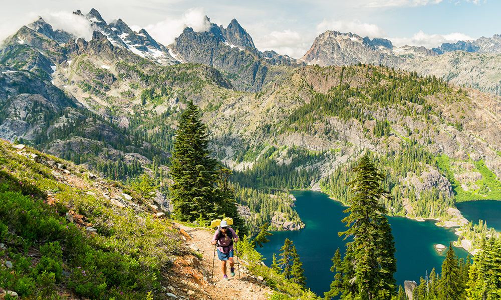 If you look closely you will notice thin clouds hugging the peaks above Spectacle Lakes in the Alpine Lakes Wilderness in the Washington Cascades.  These peaks are blocking an on-shore flow and suppressing any low cloud cover on the east side or lee side of this divide. On the other side of this divide it is overcast with a shallow marine layer under a high pressure pattern. The Pacific Crest Trail took us over a pass and to the west side (windward) side of this divide which you will see in the next photo. The weather didn’t suddenly change. We just simply walked into a different weather pattern as mountains often create their own weather.