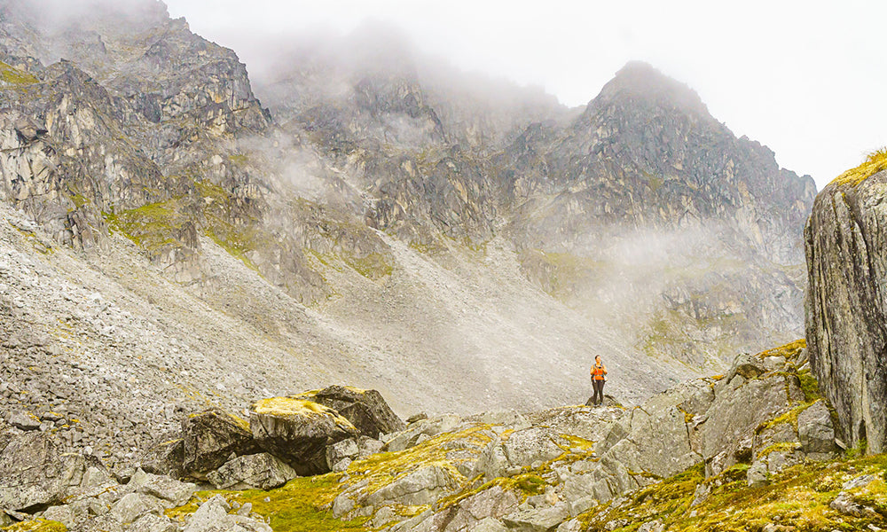 A backpacker in Alaska’s Talkeetna Mountains. The clouds obscuring the peaks are common in coastal mountains with an on-shore flow but a stable atmosphere. The clouds are not thick enough to create precipitation and thus are of little concern. At this location, we were 2500’ above where we started. This cloud type indicates a stable atmosphere and the decrease in temperature with altitude was less than the normal 5F degrees per 1000 feet. One of the best skills to have in the backcountry is cloud identification and recognizing the difference between innocuous stratus clouds in a stable atmosphere seen here and a building cumulus cloud in an unstable atmosphere that can produce impactful weather to backcountry adventurers.