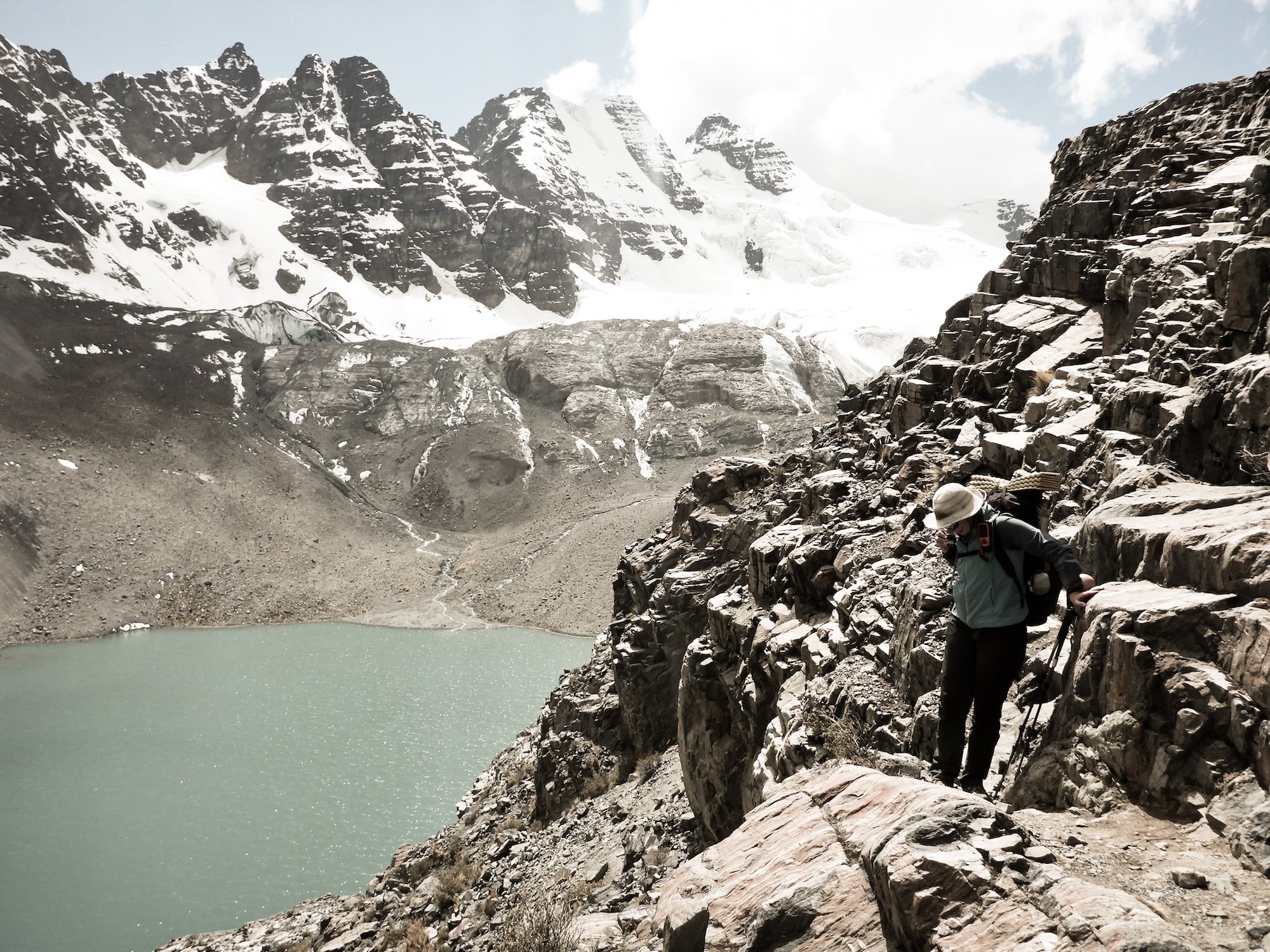 Ultralight backpacker on a rocky cliff face