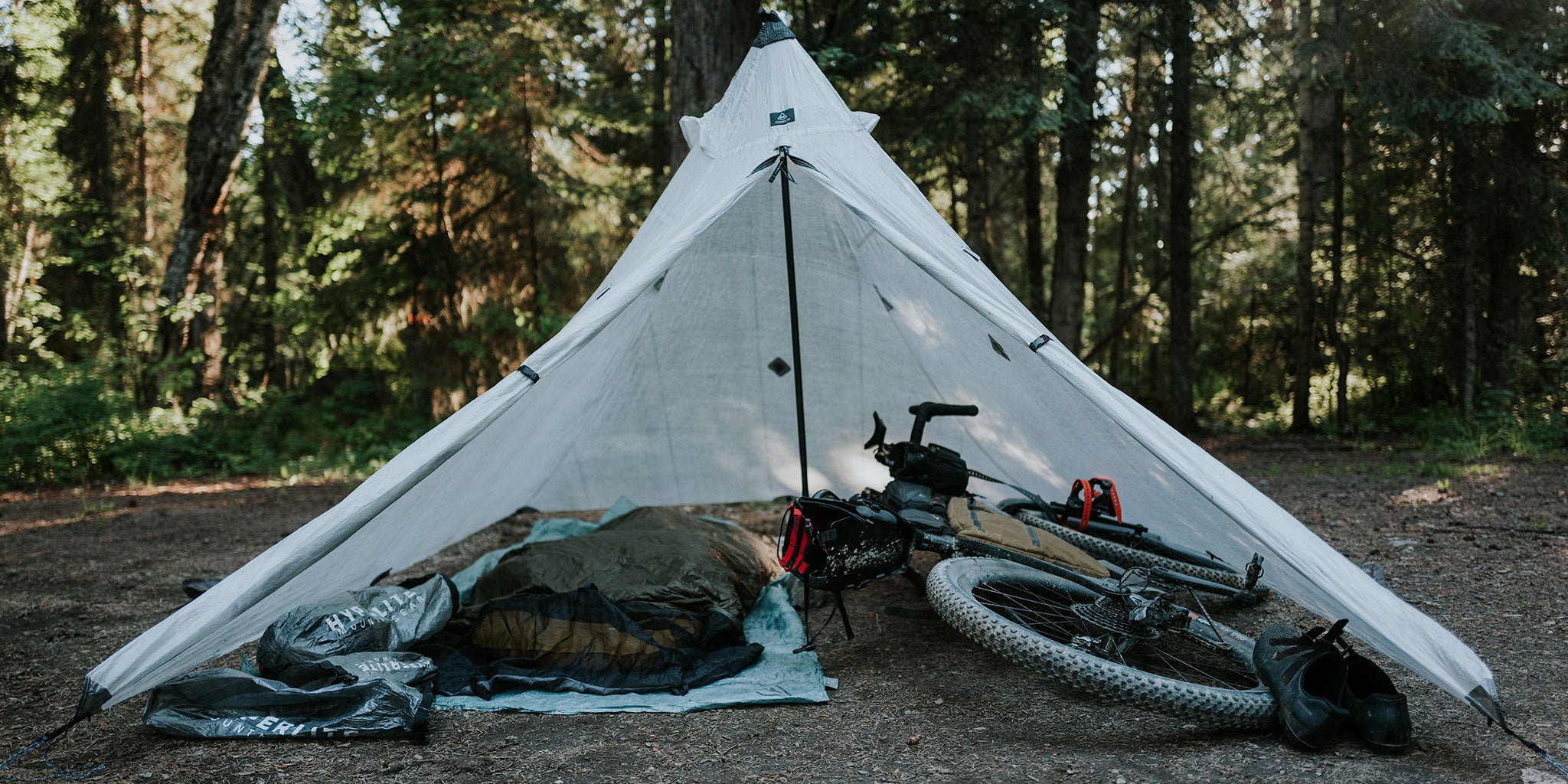 Bike packing gear under a pitched a tent