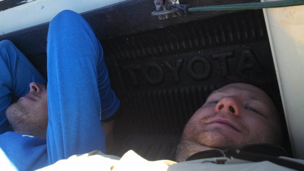 Hikers laying in bed of pickup truck