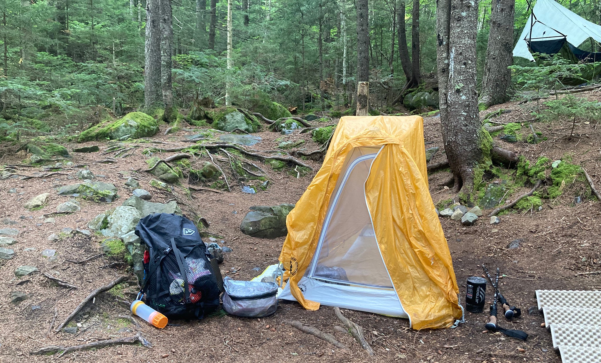 Ultralight pack and tent at camp