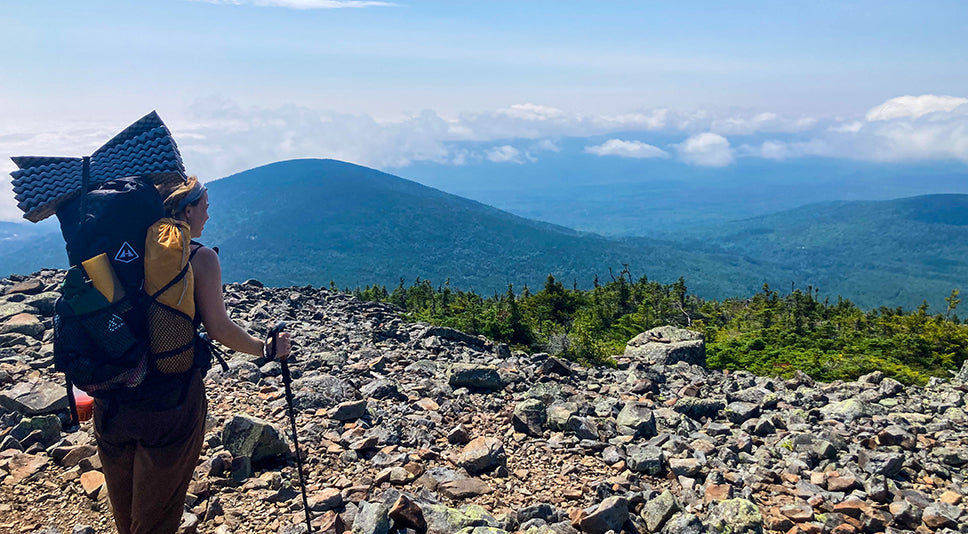 Backpacker overlooks the Maine wilderness