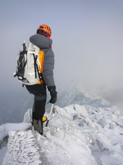 Ultralight Outdoor Ice Climber on top of snowy mountain