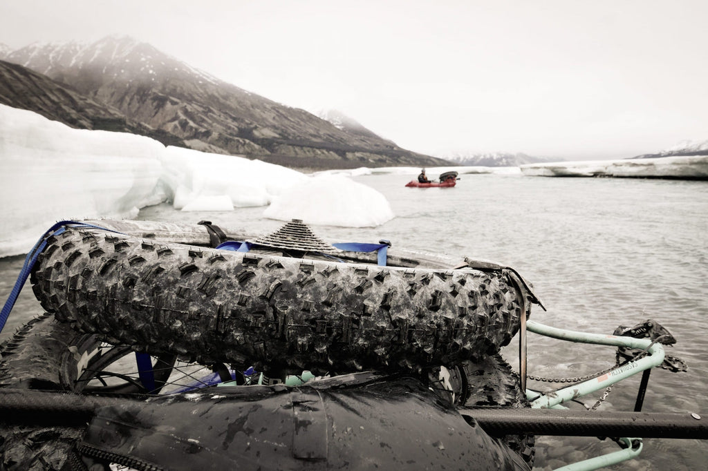 Closeup shot of large bike tire strapped to a raft