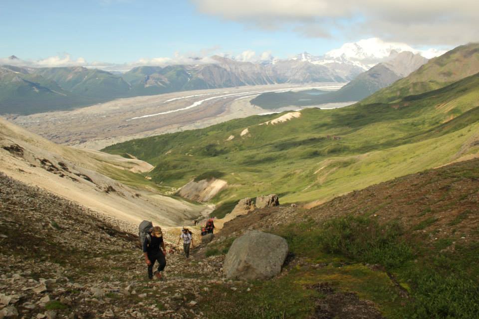 Ultralight packrafters hiking to the water