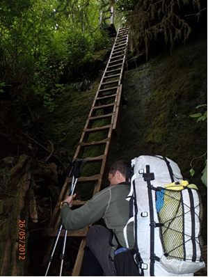 Ultralight backpacker climbing wooden ladder