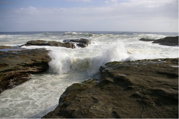 Waves crashing over rocky beach