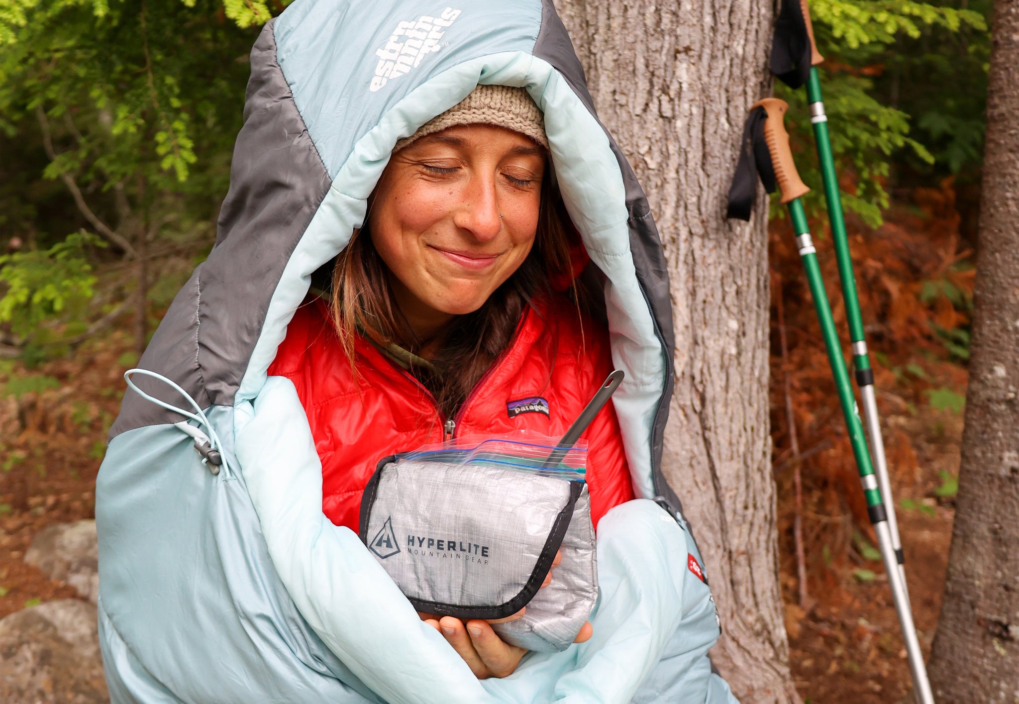 Happy hiker eating snacks from her ultralight pouch