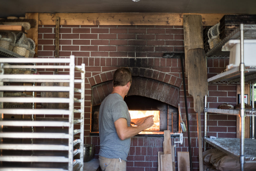 Laughing Tree Brick Oven Bakery - Charlie Muller stokes the brick oven fire