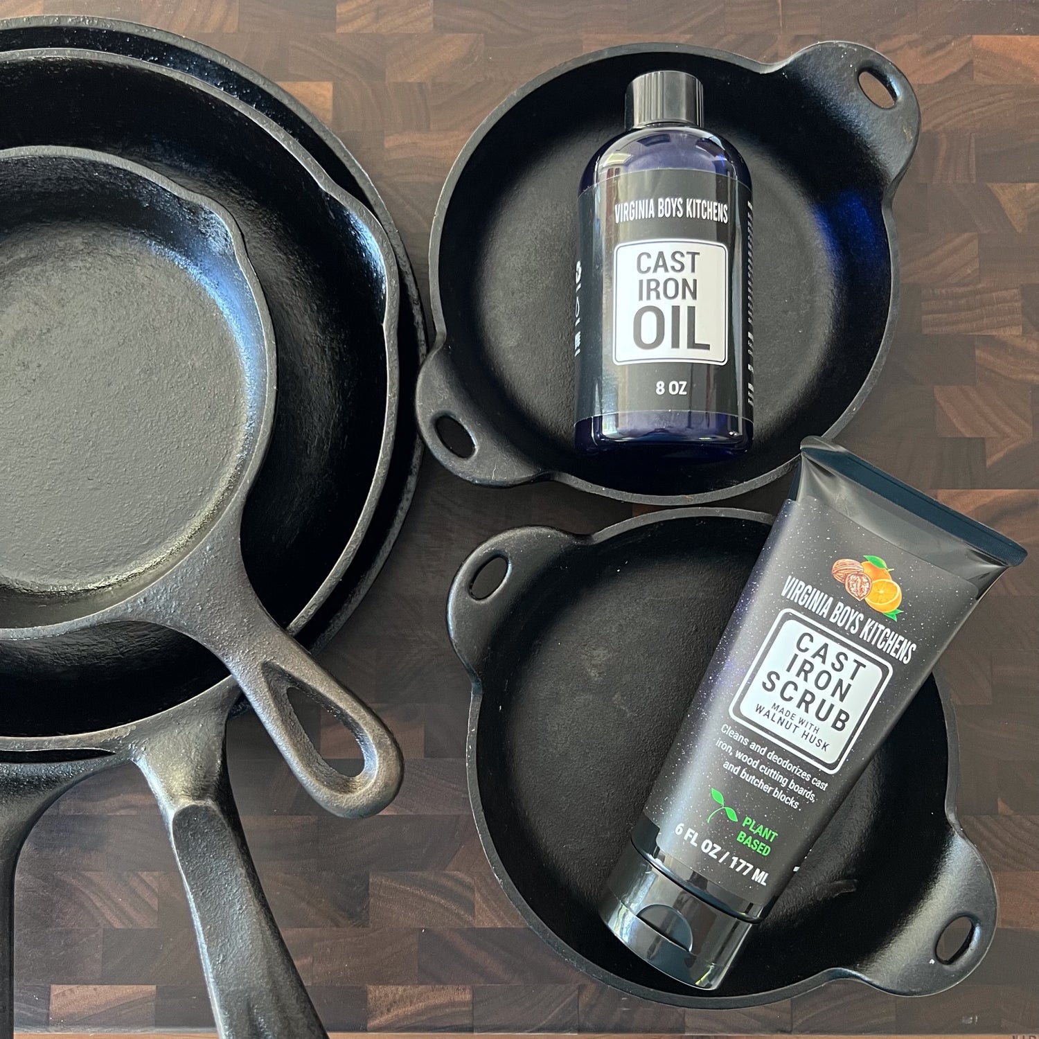 top view of cast iron pots and skillets with virginia boys kitchens cast iron oil and cast iron scrub