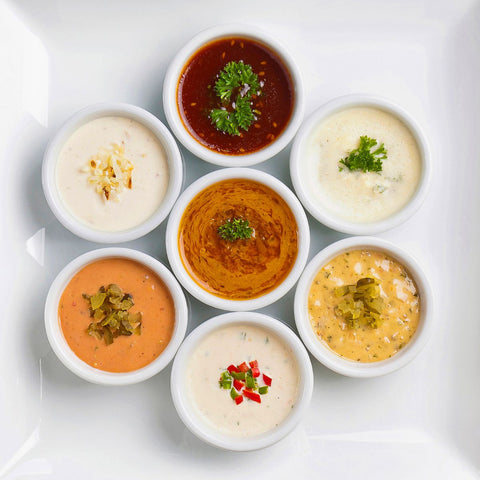 top view of seven ramekins filled with different chutneys and sauces