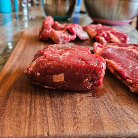 Filet mignon cuts over a wood cutting board