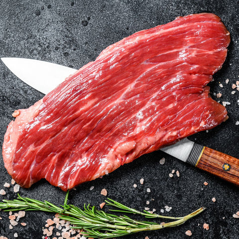 raw beef drop flank on top of a knife