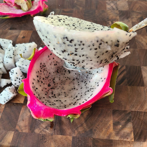 scooped out dragonfruit (pitaya) with a large spoon