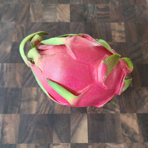 dragonfruit (pitaya) on a wooden end grain table