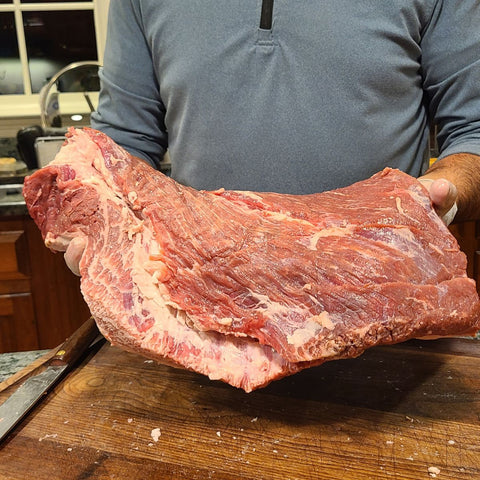 man holding an 8lb brisket