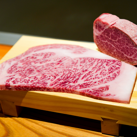 kobe beef well marbled sliced on a wooden cutting board