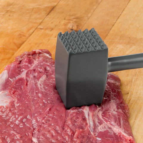 meat tenderizer beating on a piece of meat
