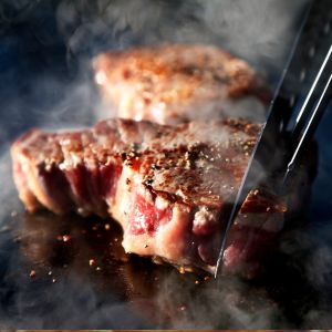 hump steak being cooked on a griddle