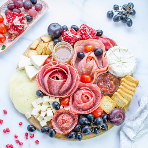 charcuterie tray with 4 different meat flowers of different meats and sizes